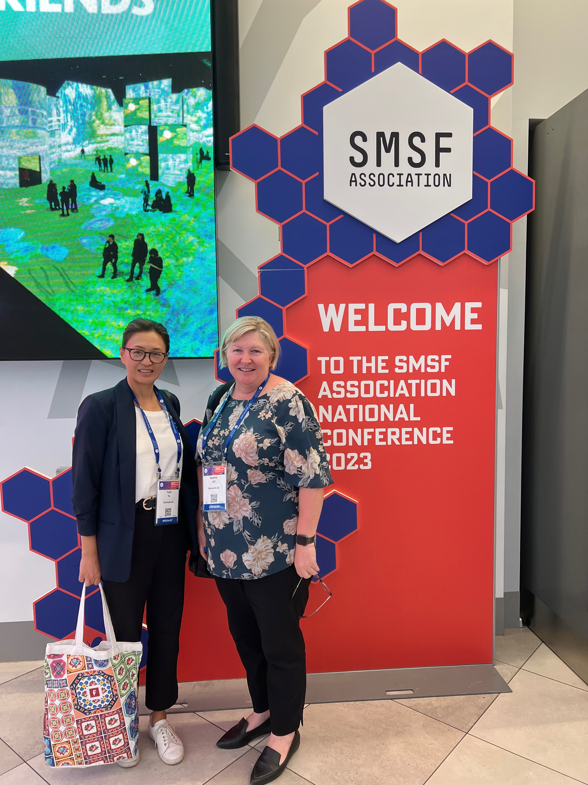 Yanli Ye, Manager and Nadine Hill, Associate standing outside of the SMSF Association Conference 2023 Hall.