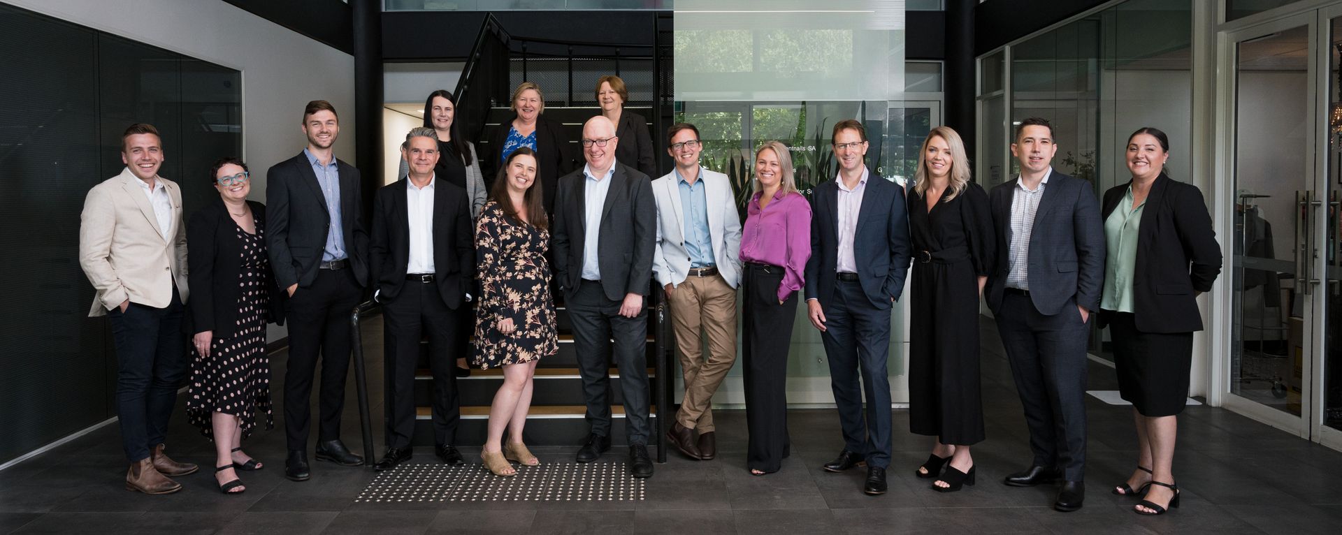 Photo of all the Partners & Principals at Brentnalls SA standing in the foyer at 255 Port Road, Hindmarsh 5007.