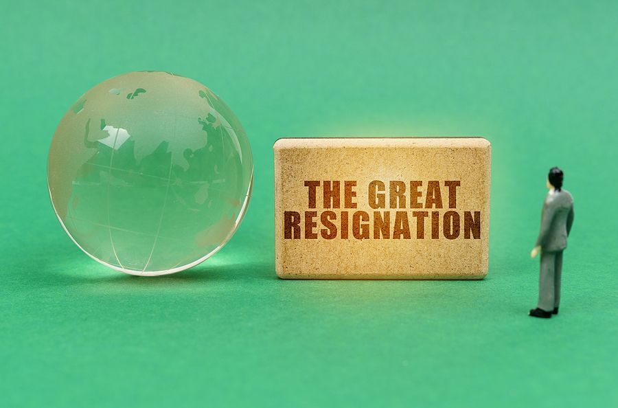 Vector image of a character looking at sign (the great resignation) and glass globe.