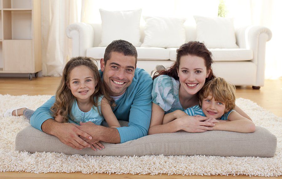 Happy family on floor lying in living-room.