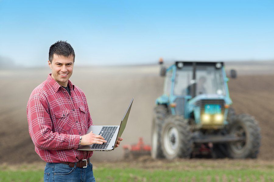 Farmer With Laptop In The Field