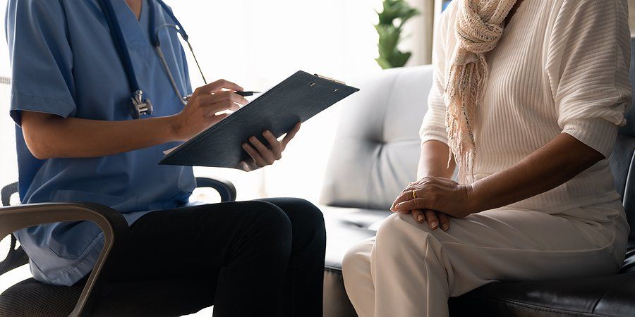 Practice nurse working with a patient.