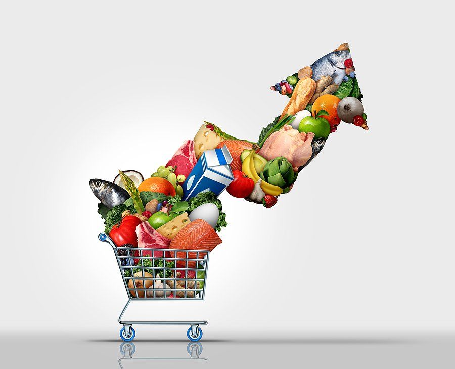 Increasing Inflation and rising grocery prices or surging cost of supermarket groceries as an inflationary financial crisis concept and the rise of food costs coming out of a shopping cart shaped as an arrow with 3D render elements.