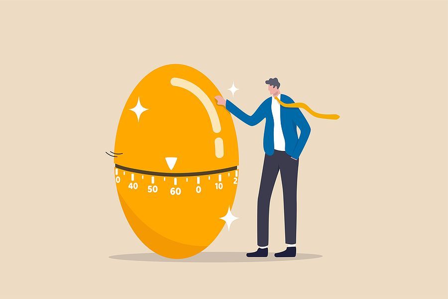 Cartoon image of a business person standing next to a retirement nest egg with an age marker as a potential retirement age.