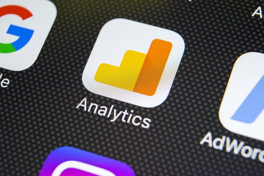 Google Analytics application icon on Apple iPhone X screen close-up. Google Analytics icon. Google Analytics application.