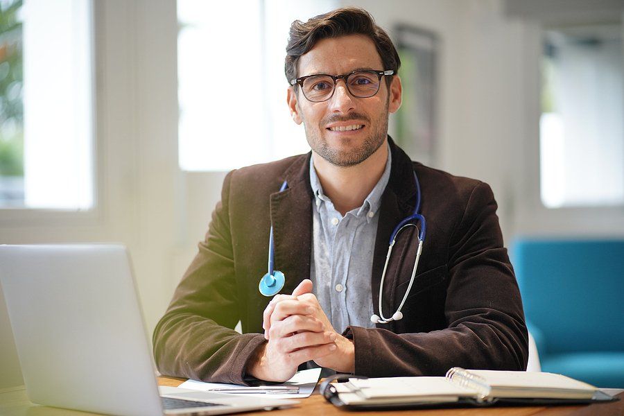 Smiling handsome doctor in an office.