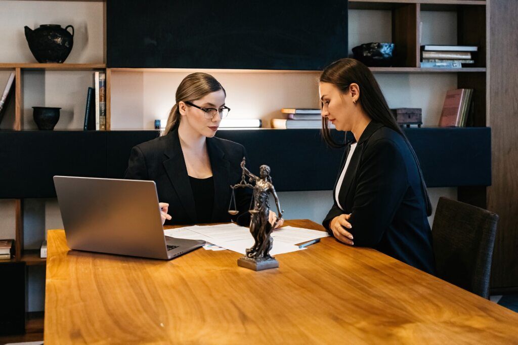 Two Women in Business Suits at a Table — Hannaway Lawyers in Port Macquarie, NSW