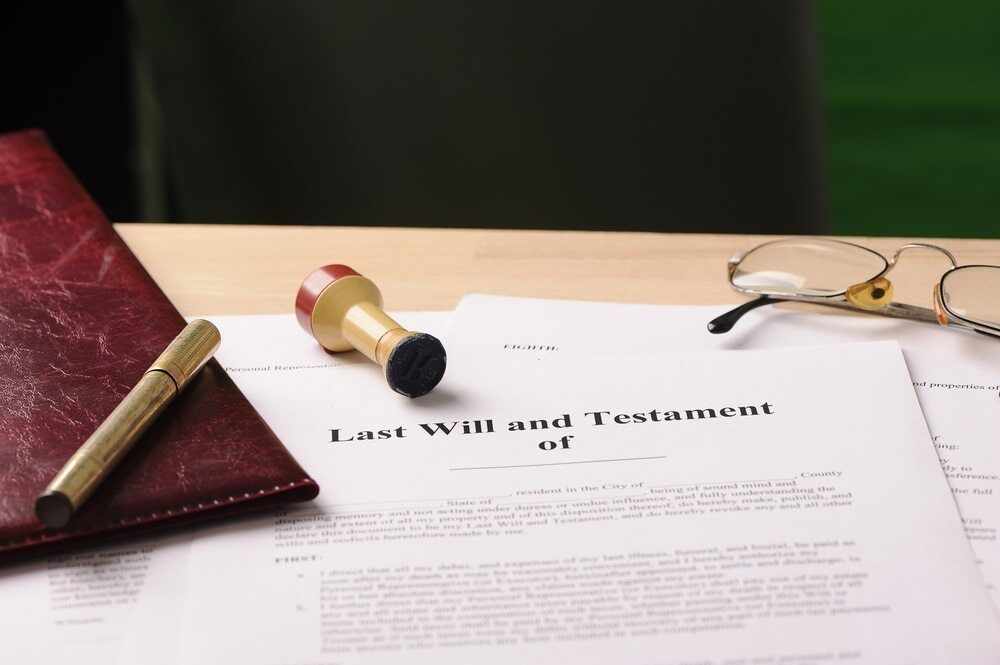 Last Will and Testament, Stamp, Pen, Glasses, and a Leather Bound Book — Hannaway Lawyers in Port Macquarie, NSW