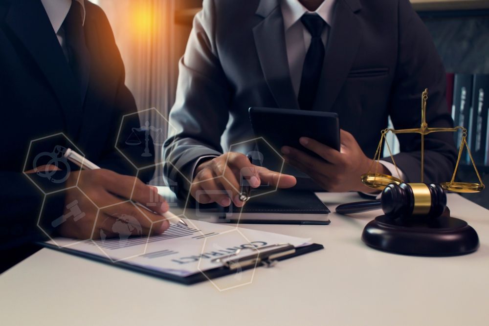 Two Lawyers In Suits Working At Desk Tablet
