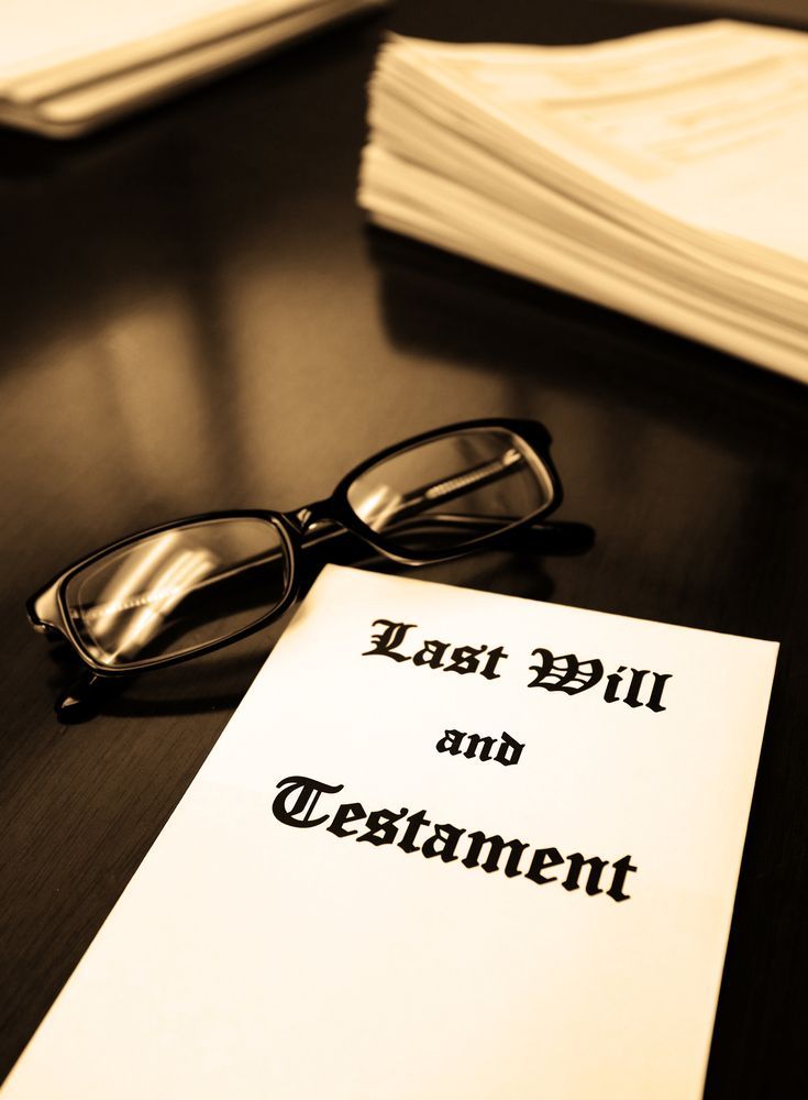 A Last Will and Testament With Glasses on a Dark Table — Hannaway Lawyers in Port Macquarie, NSW