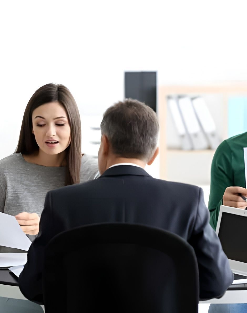 Three People Seated at a Table, in an Office — Hannaway Lawyers in Forster, NSW