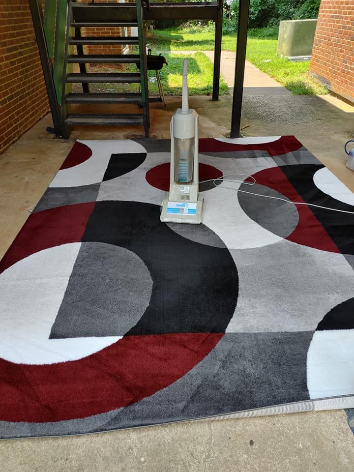 A vacuum cleaner is sitting on top of a rug.
