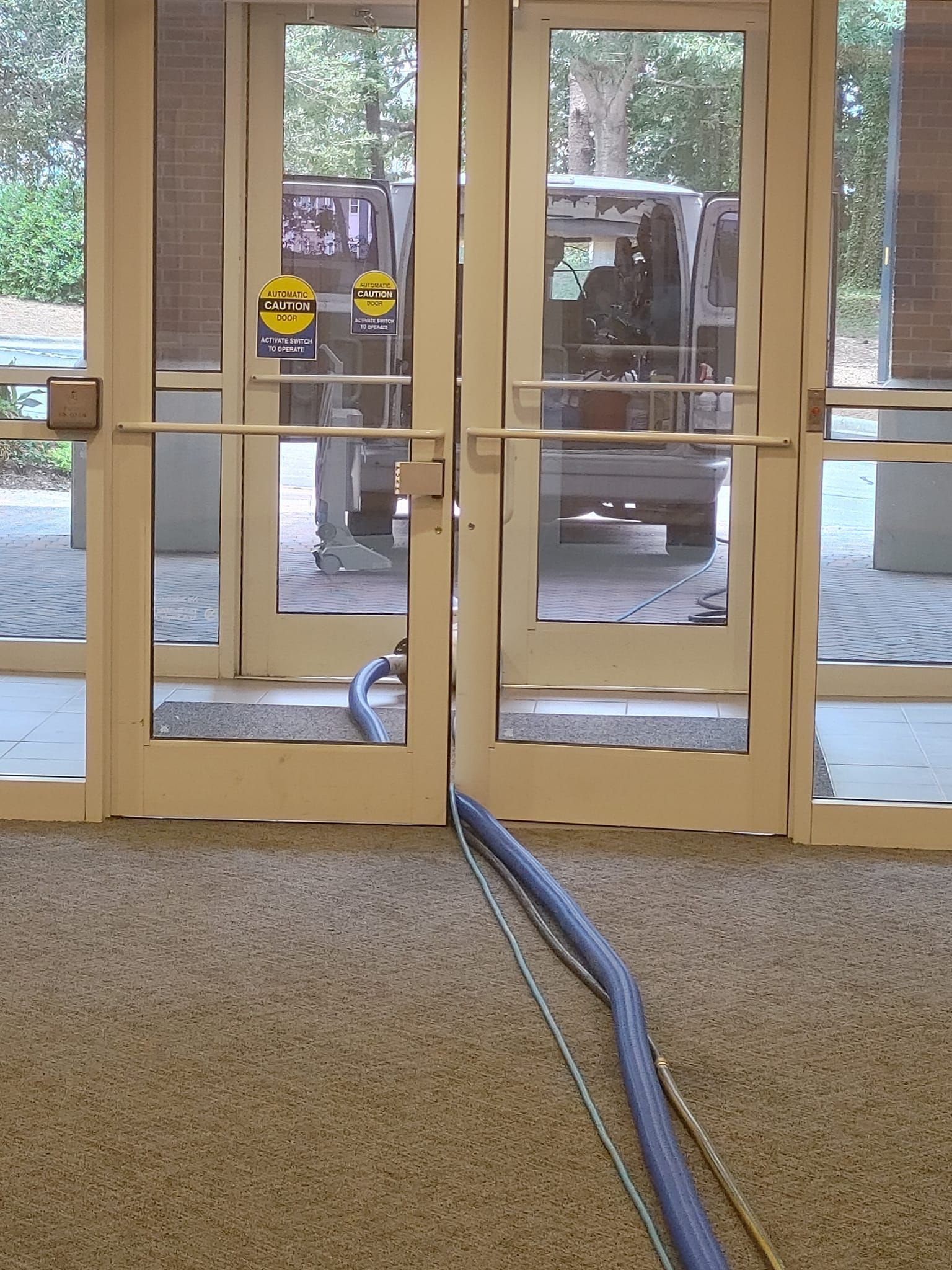 A vacuum cleaner is sitting in front of a glass door