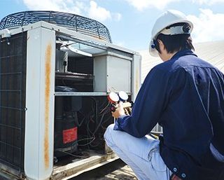 Air Conditioning Services — Technician Repairing HVAC Unit in Menifee, CA