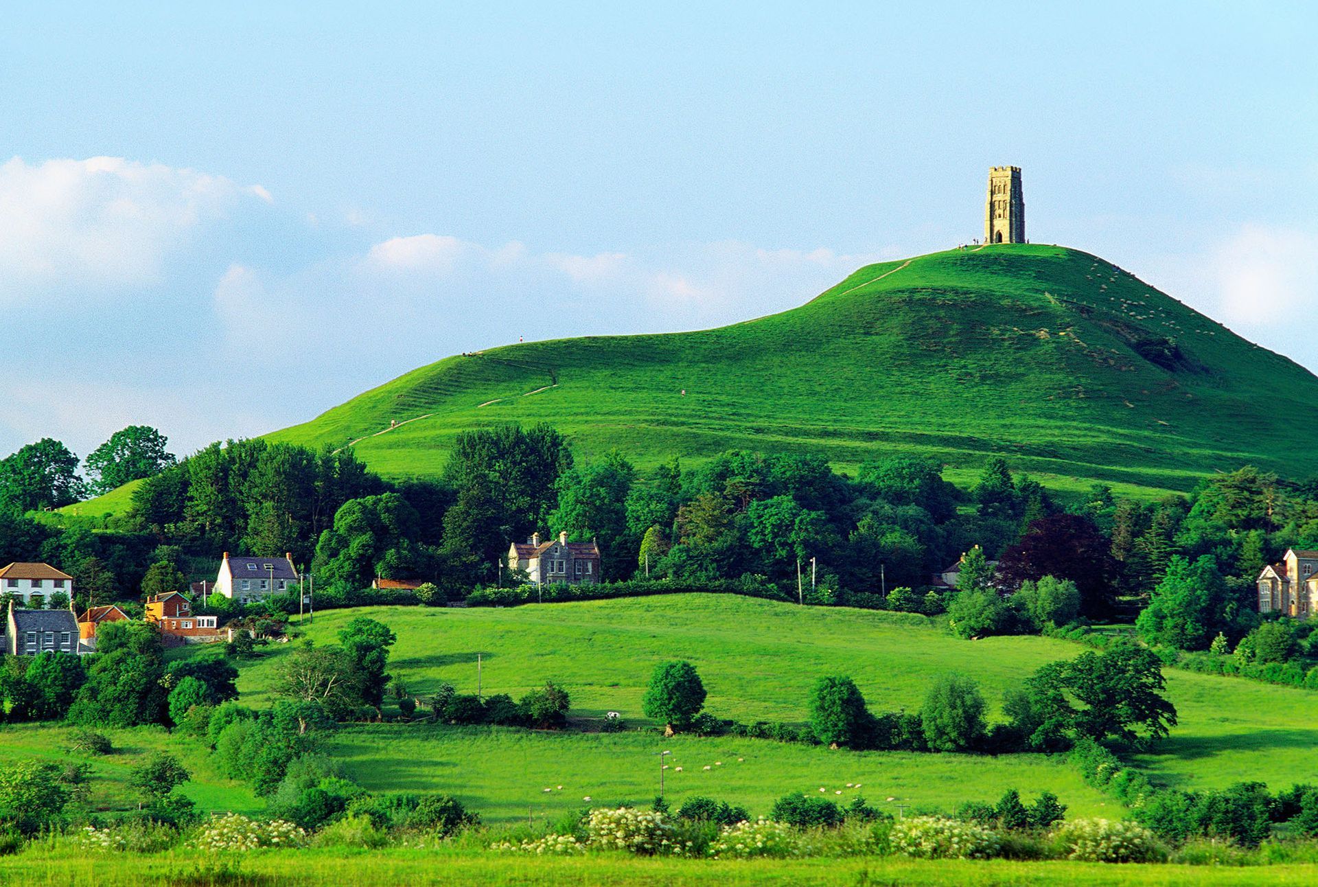 A green hill with a tower on top of it