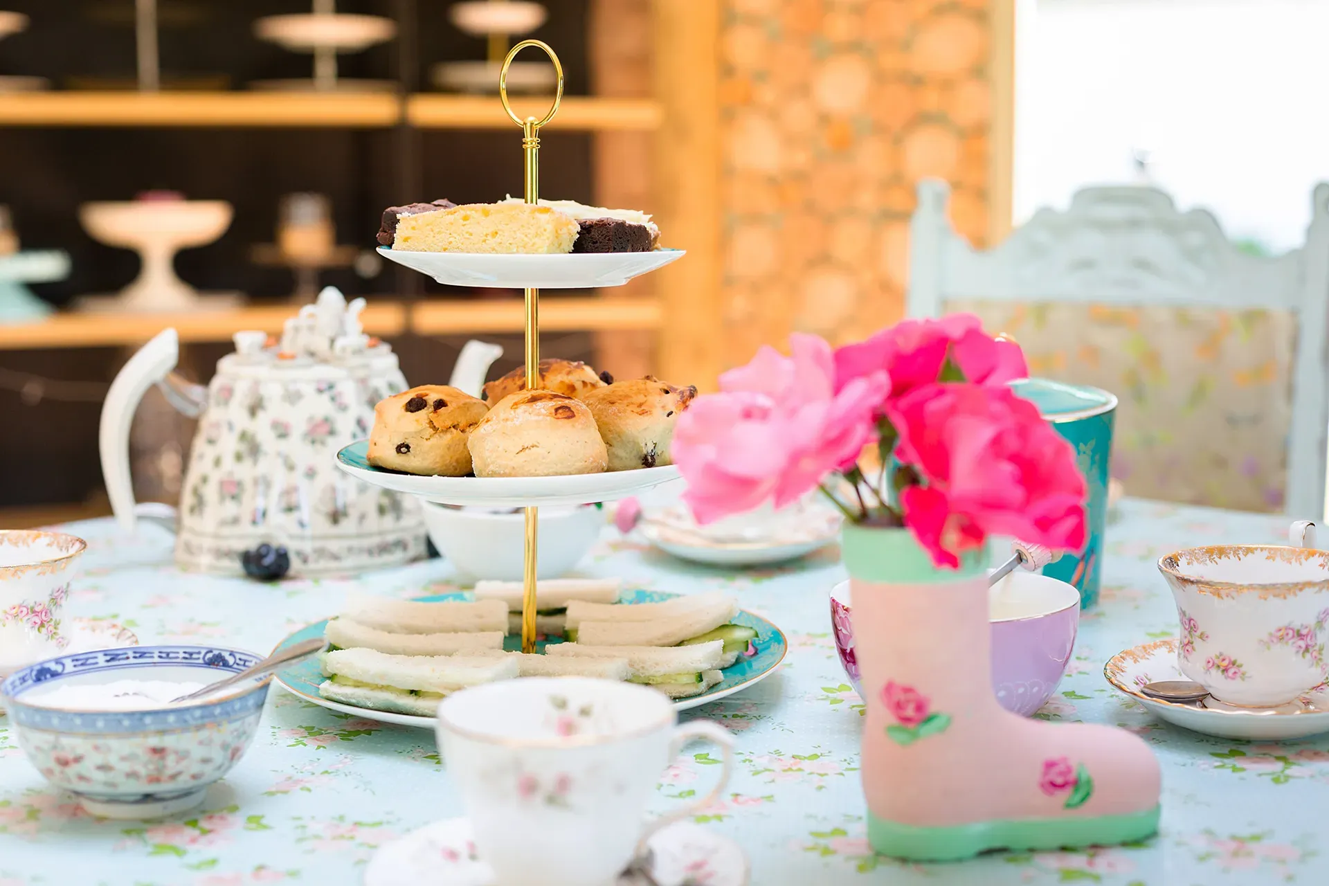 A table topped with plates of food and cups of tea.