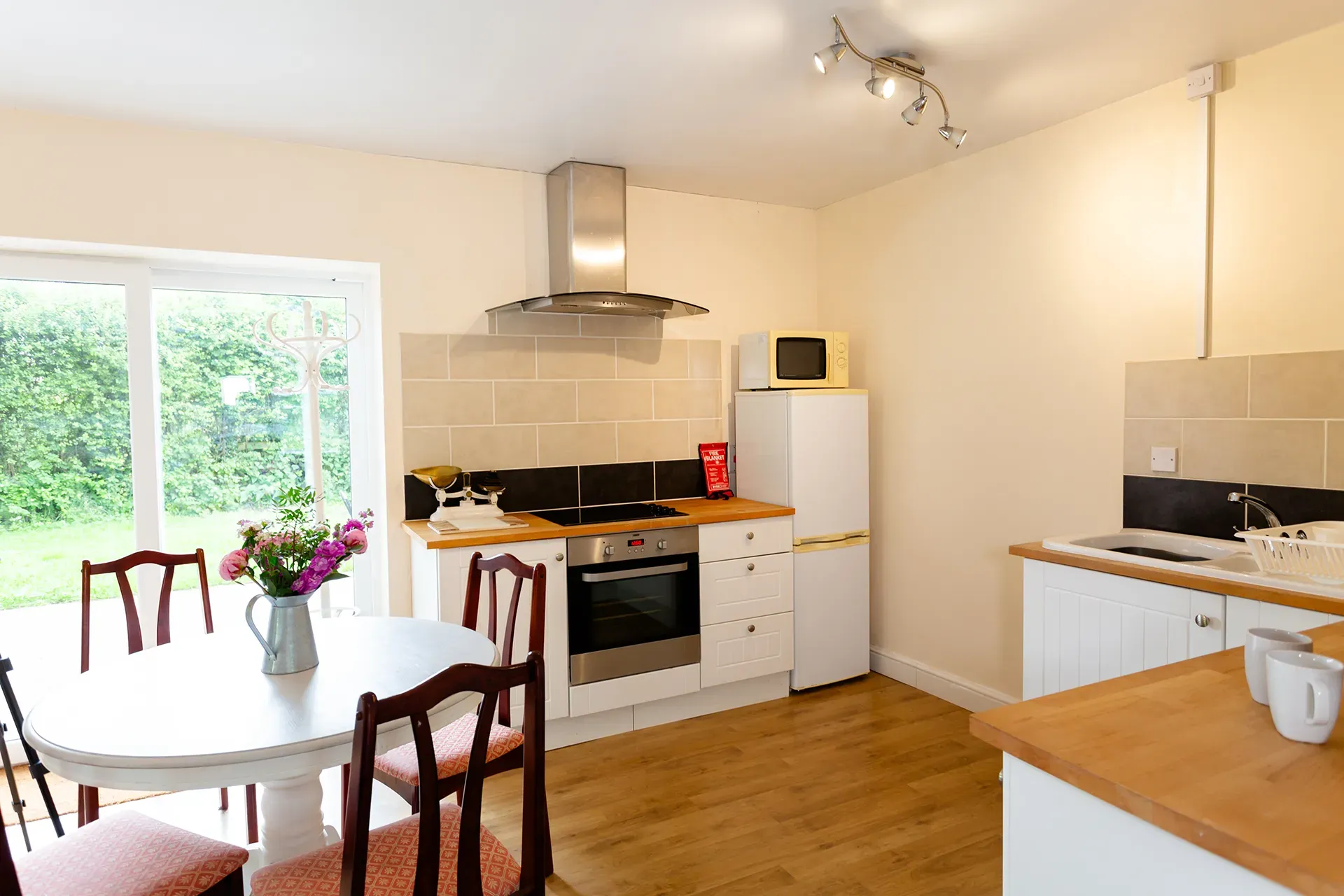 A kitchen with a table and chairs and a refrigerator