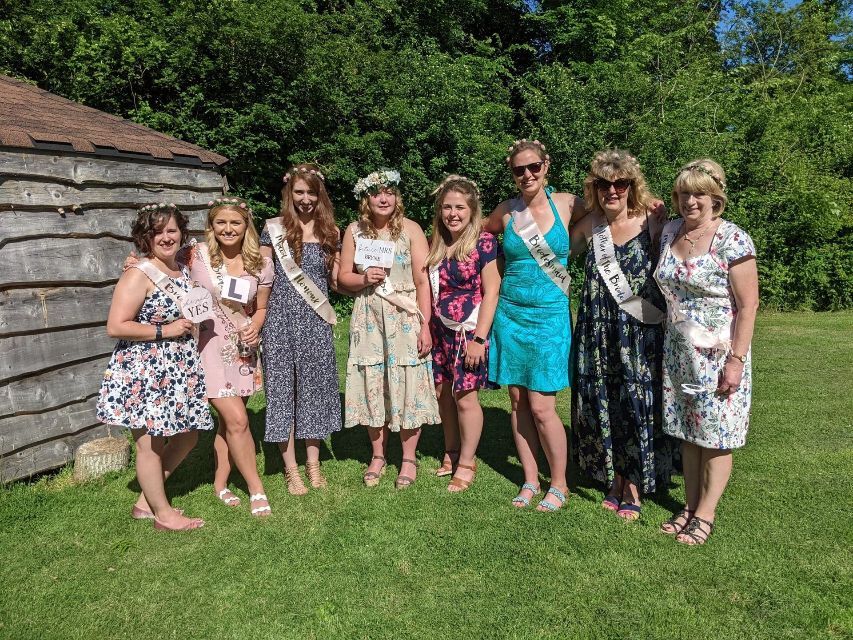 A group of women are posing for a picture in a field.