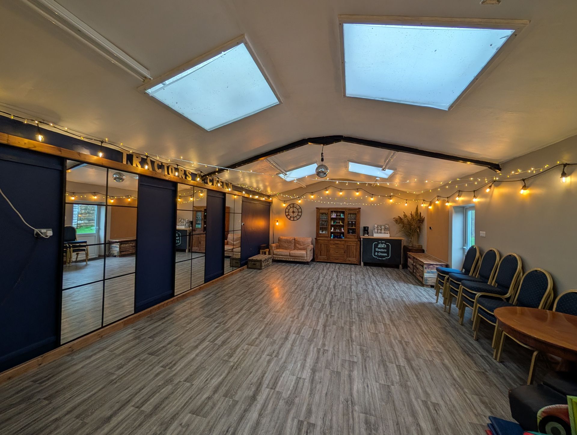 A large room with mirrors and festoon lights