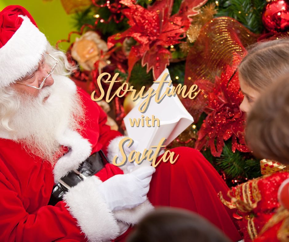 Santa Claus reading to children in front of a Christmas tree;