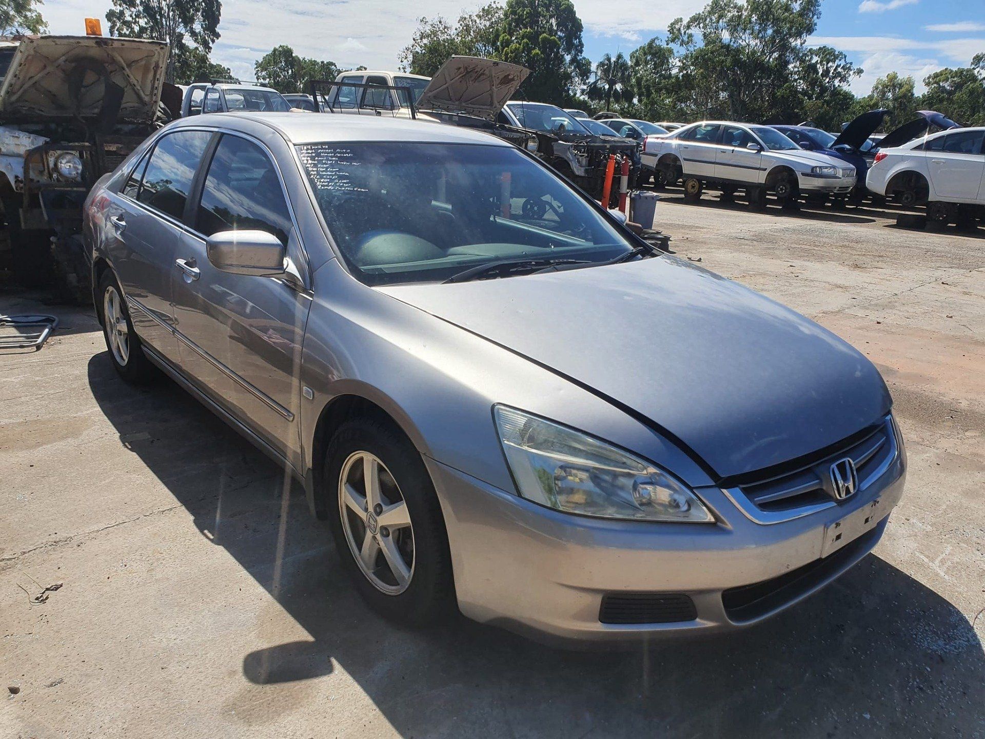 Silver Car in Wreckers Yard — Local Vehicle Scrapping And Repair Professionals in Bondoola, QLD
