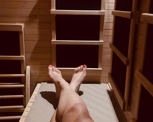 A woman 's feet are crossed in a sauna