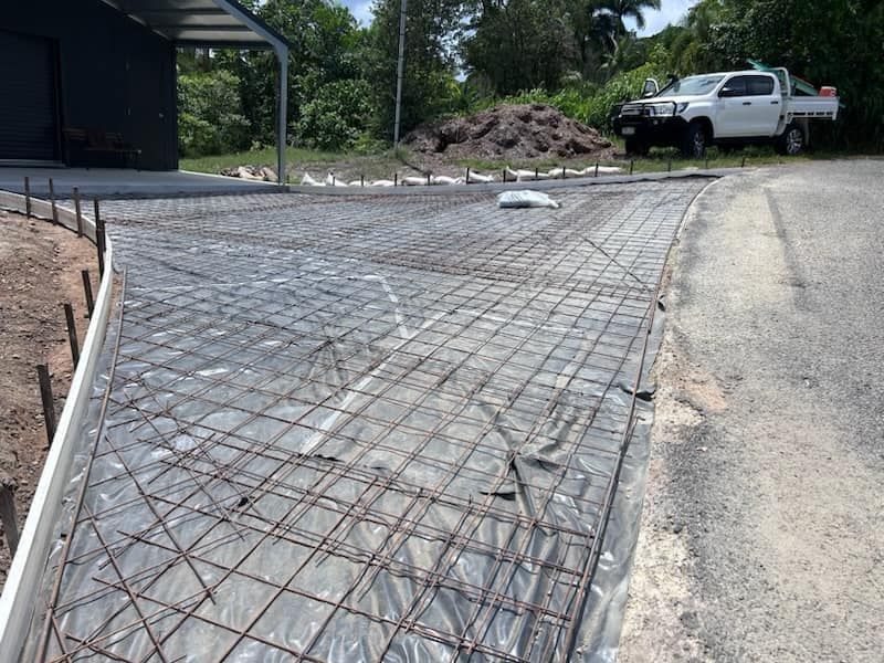 A White Truck Is Parked On The Side Of The Road Next To A Concrete Driveway — Core Concrete in Cairns, QLD