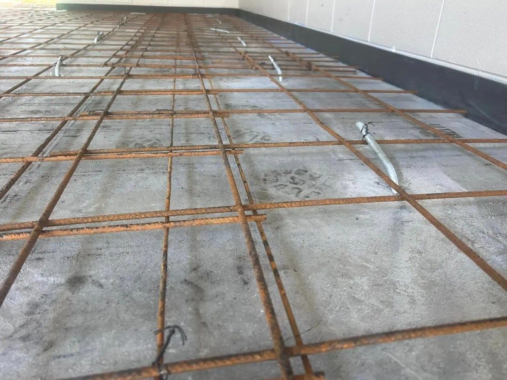 A Close Up Of A Concrete Floor With A Metal Mesh — Core Concrete in Cairns, QLD