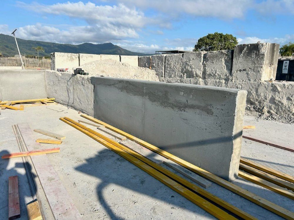 A Concrete Wall Is Being Built With A Yellow Ruler — Core Concrete in Cairns, QLD