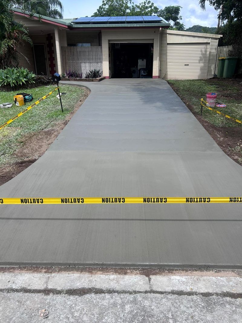 A Concrete Driveway Is Being Built In Front Of A House — Core Concrete in Cairns, QLD