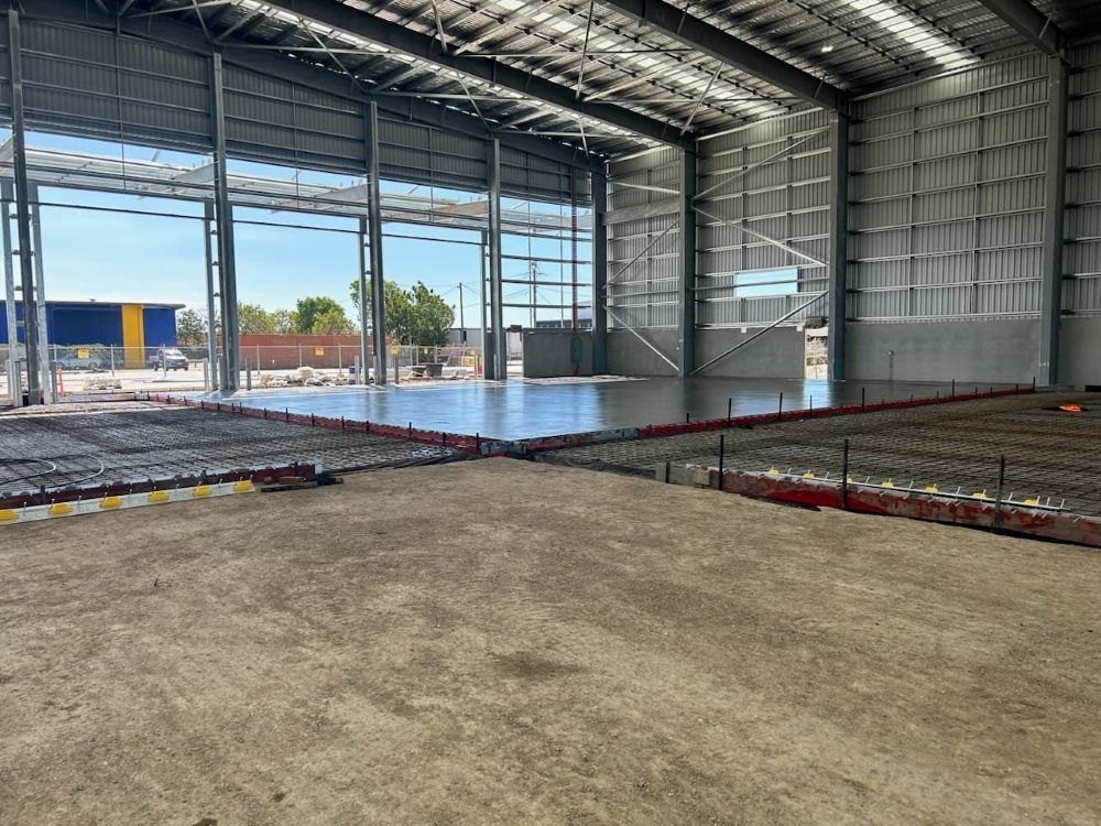 A Large Warehouse With a Concrete Floor Under Construction — Core Concrete in Innisfail, QLD