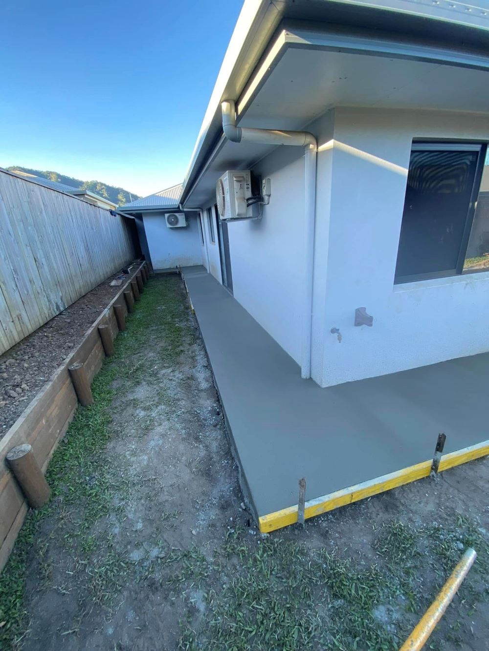 A Concrete Walkway is Being Built in Front of a House — Core Concrete in Innisfail, QLD