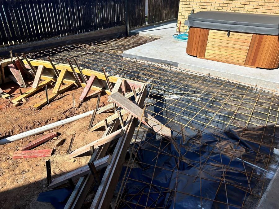 A Hot Tub is Being Built in the Backyard of a House — Core Concrete in Innisfail, QLD
