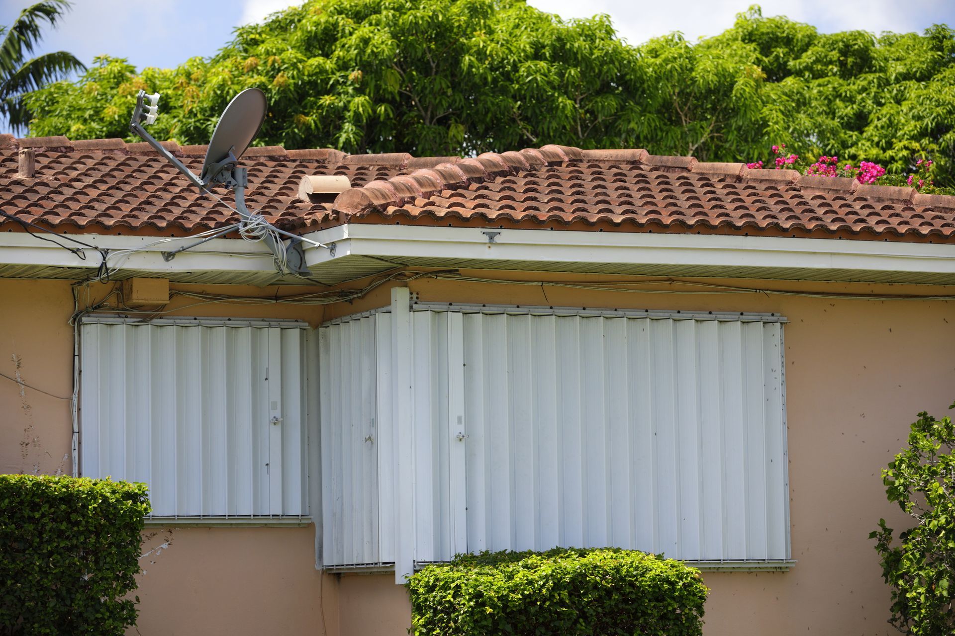 A home with storm shutters installed on its windows.