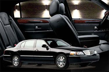Black Lincoln Town Car sedan with black leather interior.