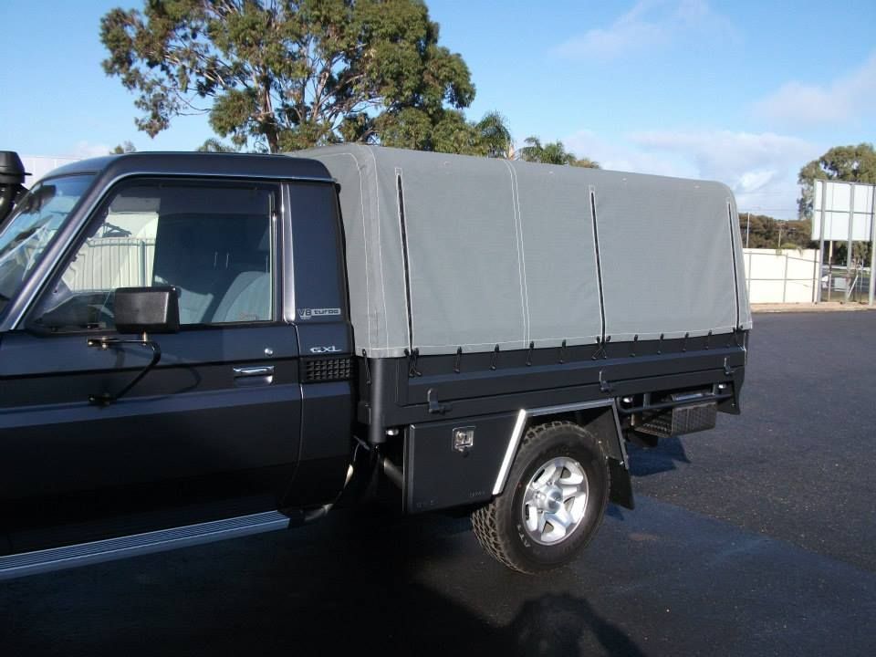 A close up of a canopy tarp on a truck.