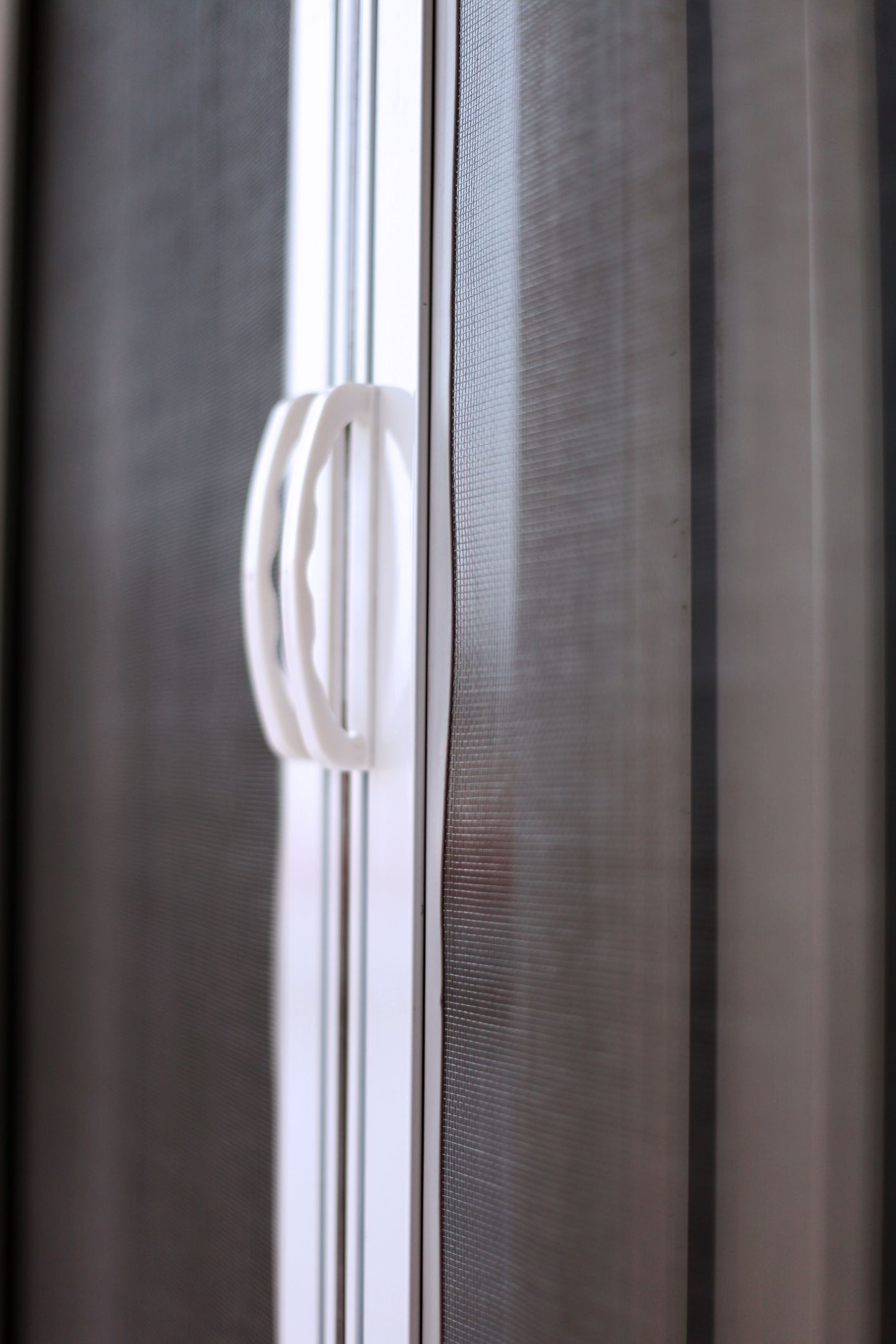 A close up of a shower door with a handle.