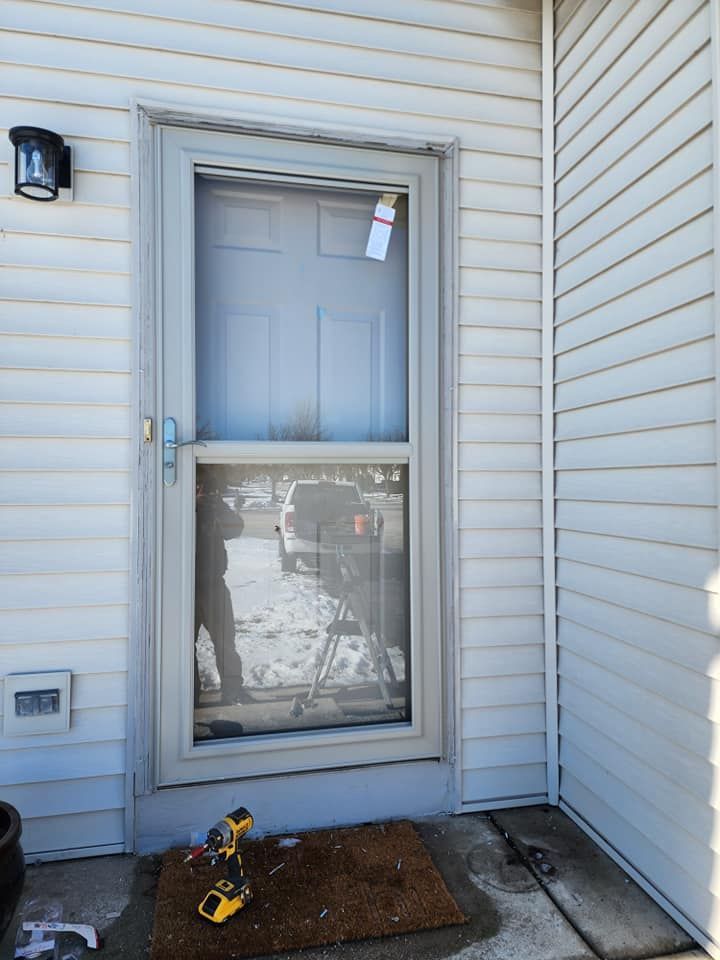 White house entry door with frosted glass, a doormat, and a pair of yellow shoes on the porch