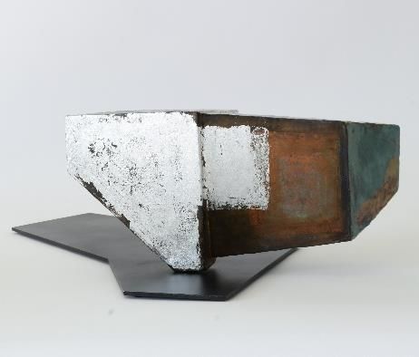 Ceramic sculpture by Japanese artist Chisato Yasui. This piece features a black metal base into which a ceramic with geometric cutouts is inserted.