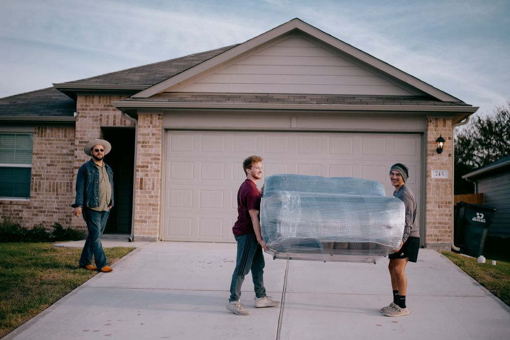 A group of people are carrying a car in front of a house | Residential Moving in San Marcos, TX