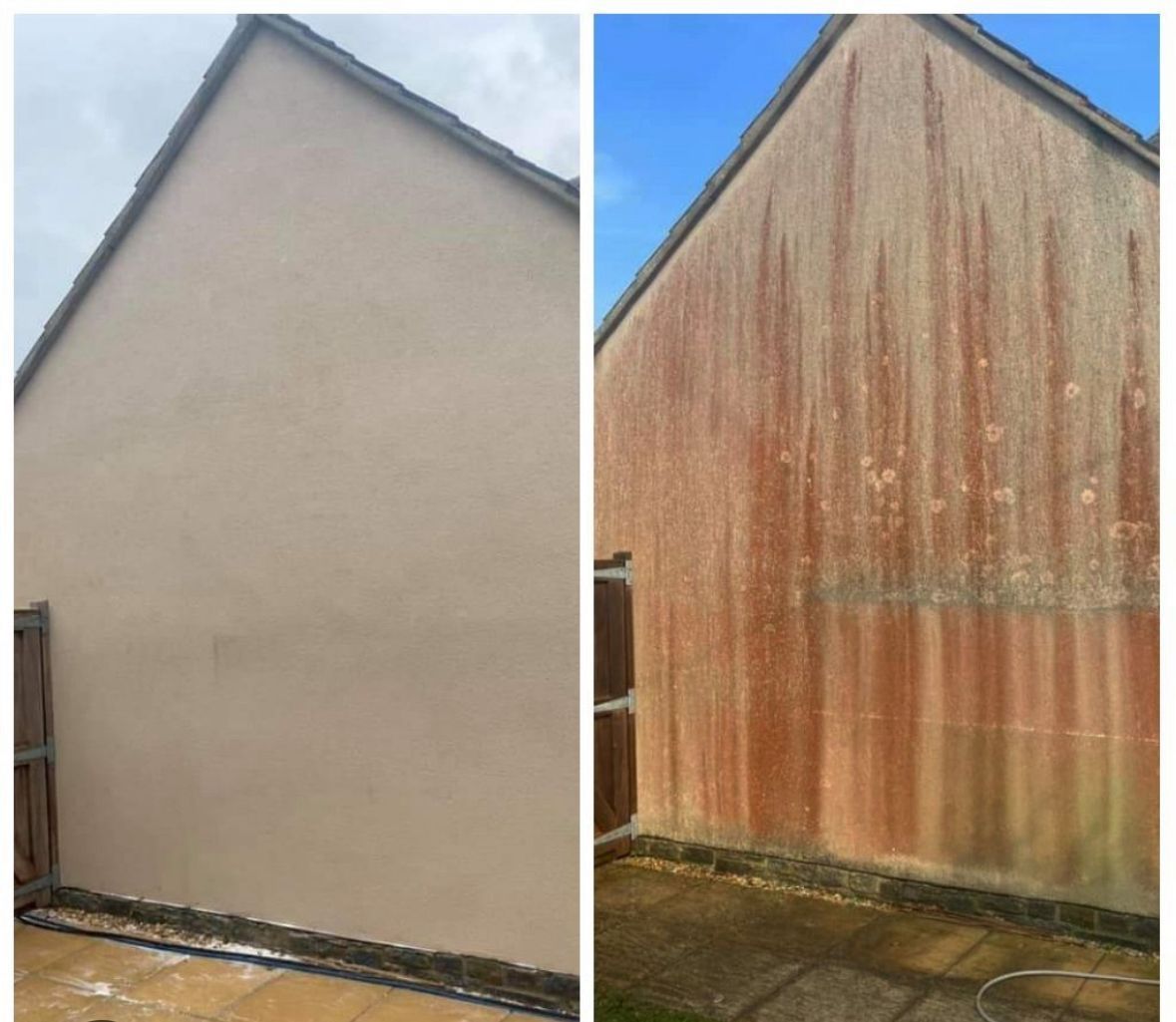 Man pressure washing a house with visible algae.