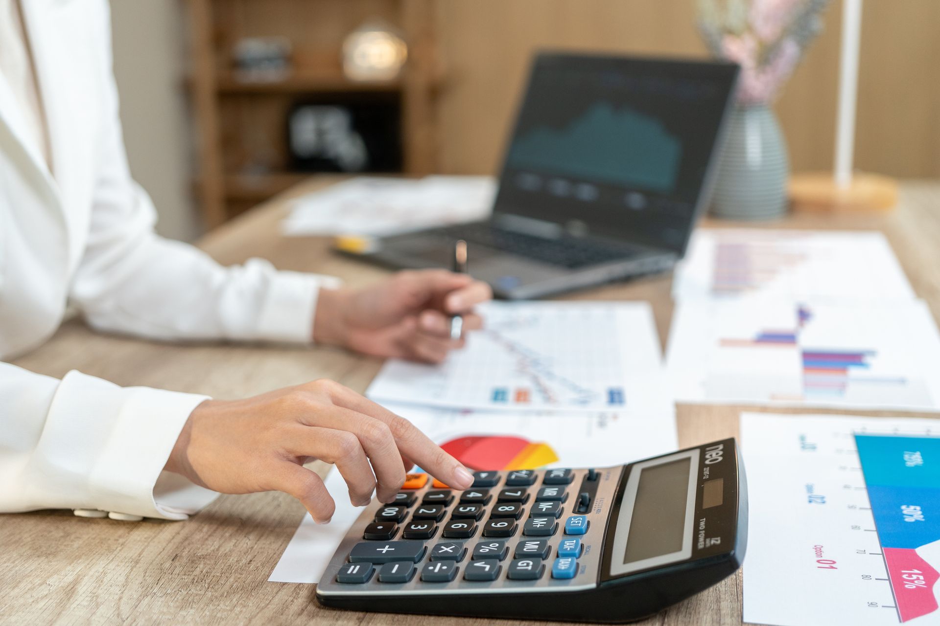 Businesswoman managing tax and accounting tasks in a modern office.