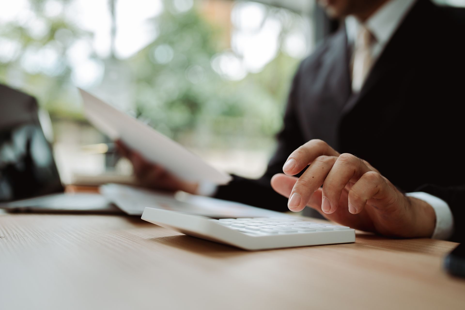 A CPA firm professional calculating personal taxes for a client.