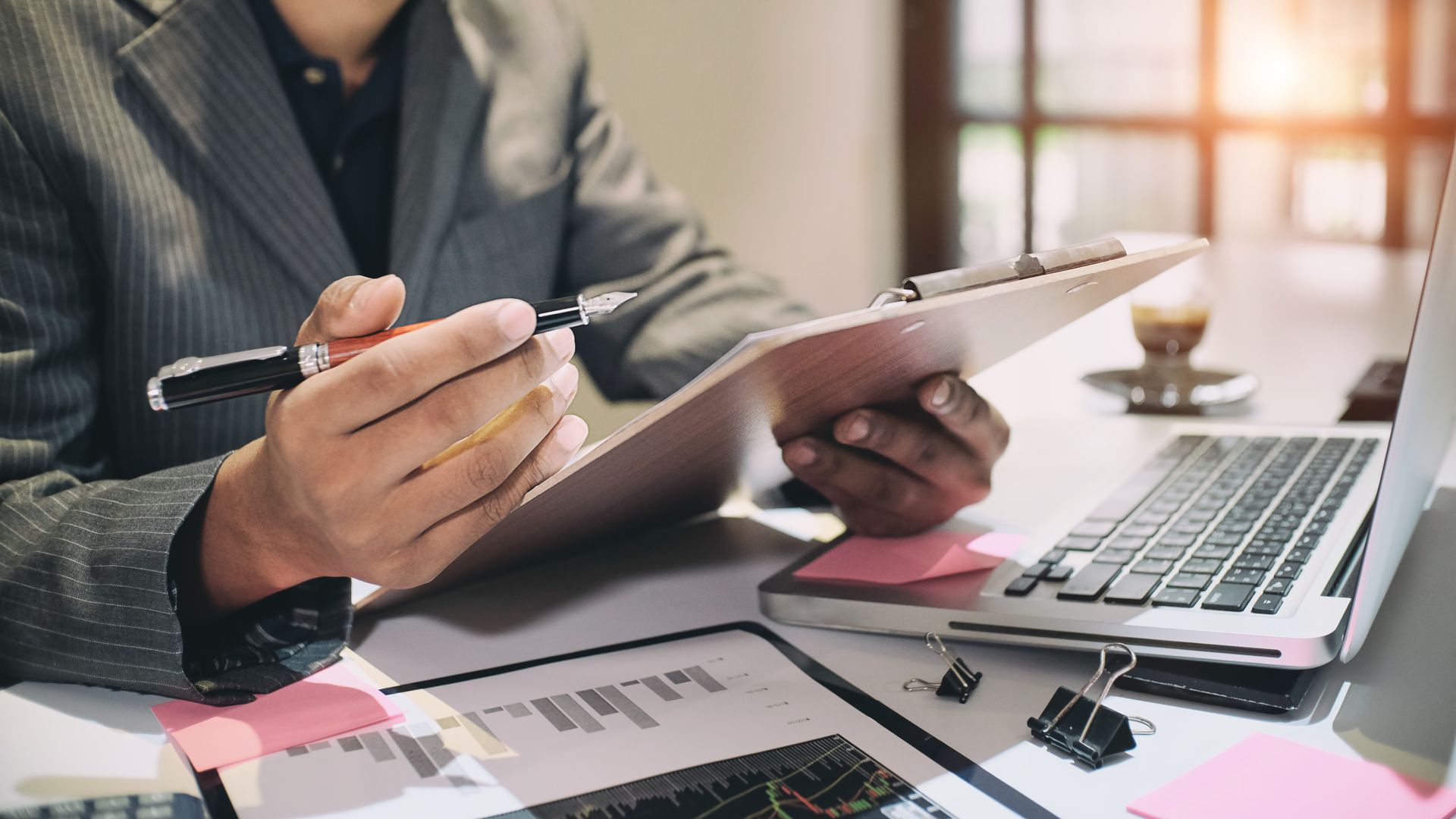 Auditor analyzing data sheets with an expert corporate CPA service. Auditor analyzing data sheets with an expert corporate CPA service.