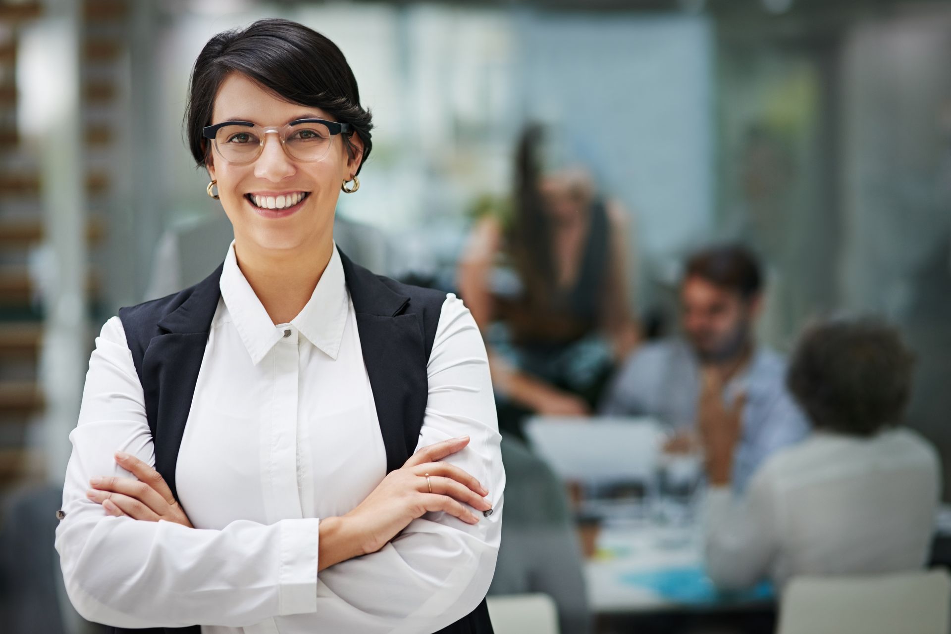 Female accountant stands proudly with a smile in a portrait with arms crossed at CPA firm for trust. Female accountant stands proudly with a smile in a portrait with arms crossed at CPA firm for trust.