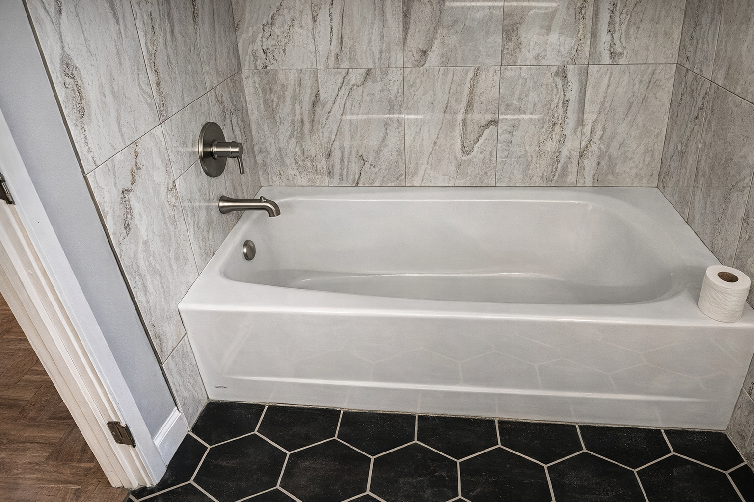 Chrome shower valve with white levers, mounted on white brick tile wall.