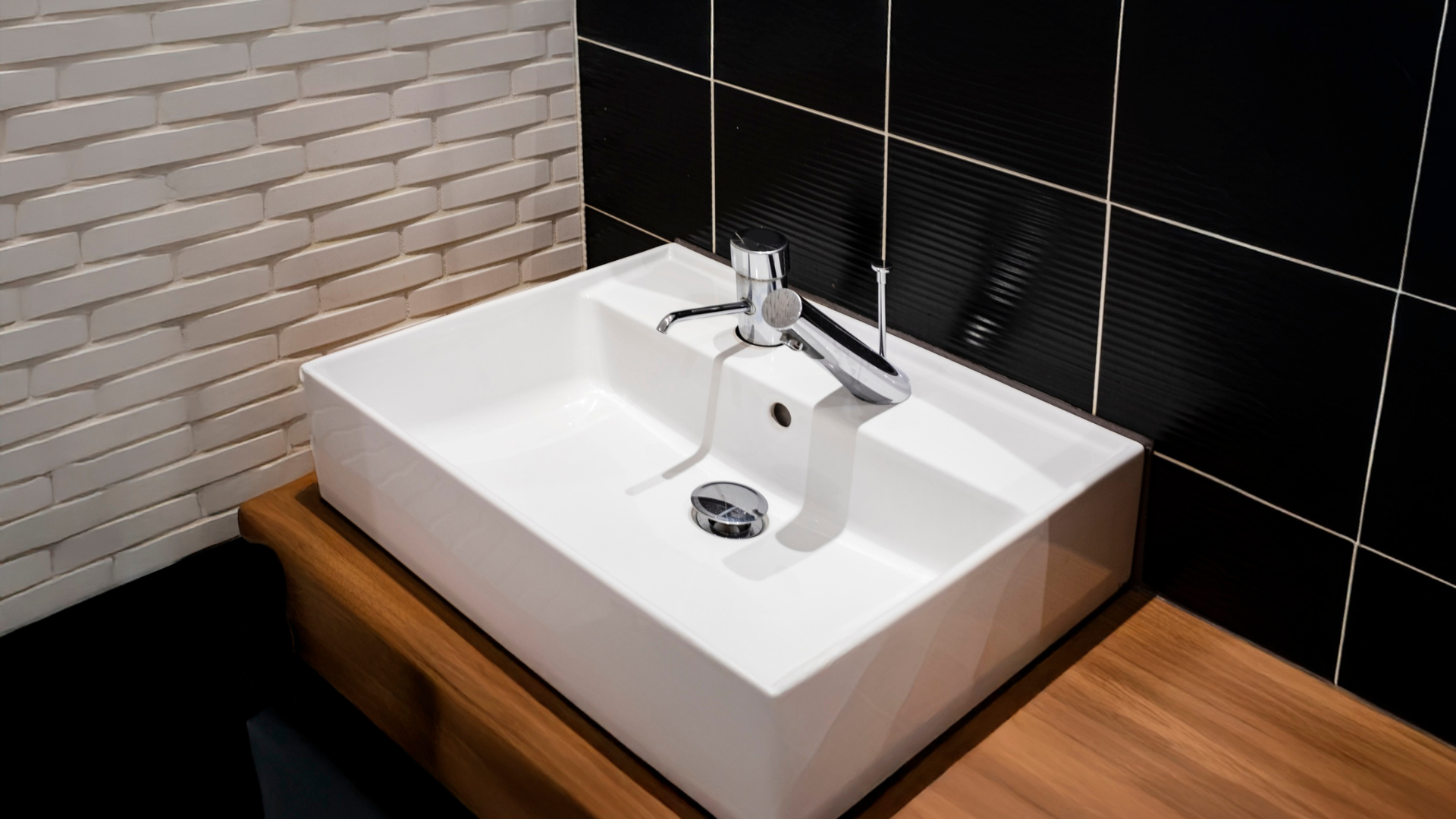 Two water heaters with copper pipes, a pressure gauge, and an expansion tank in a utility room.