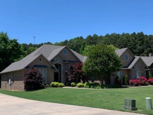 A row of houses with a lot of trees in the background