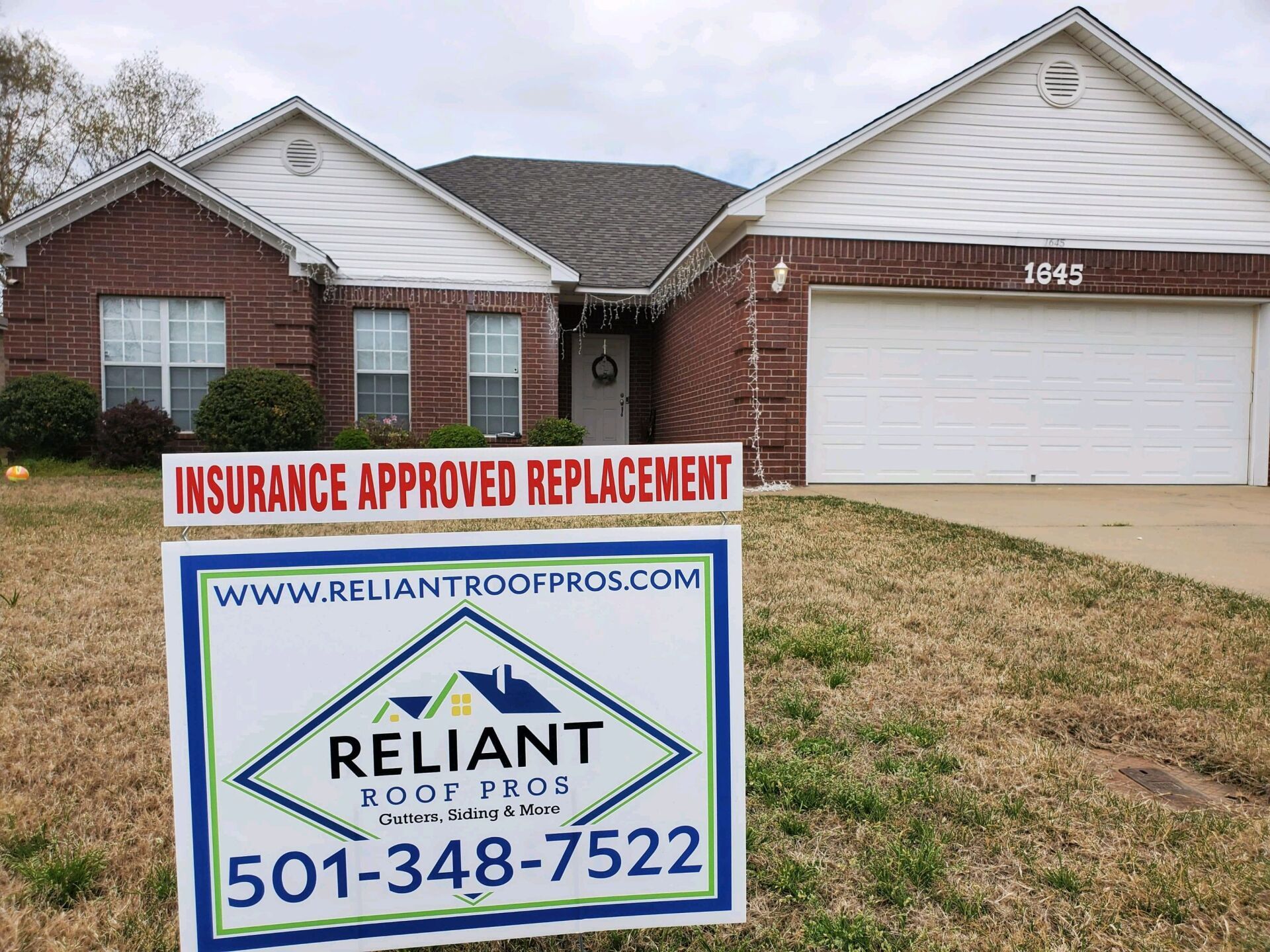 A reliant roof pros sign in front of a house
