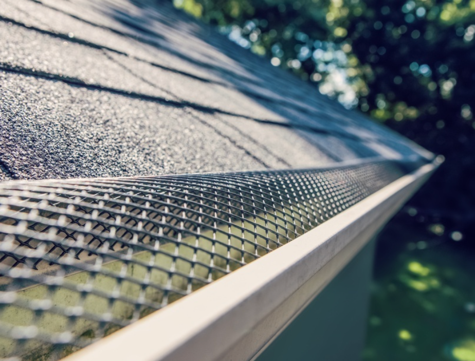 A close up of a gutter with a mesh on it